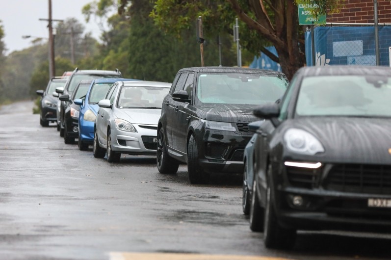 Cars lined up at a drive-through clinic in Manly.