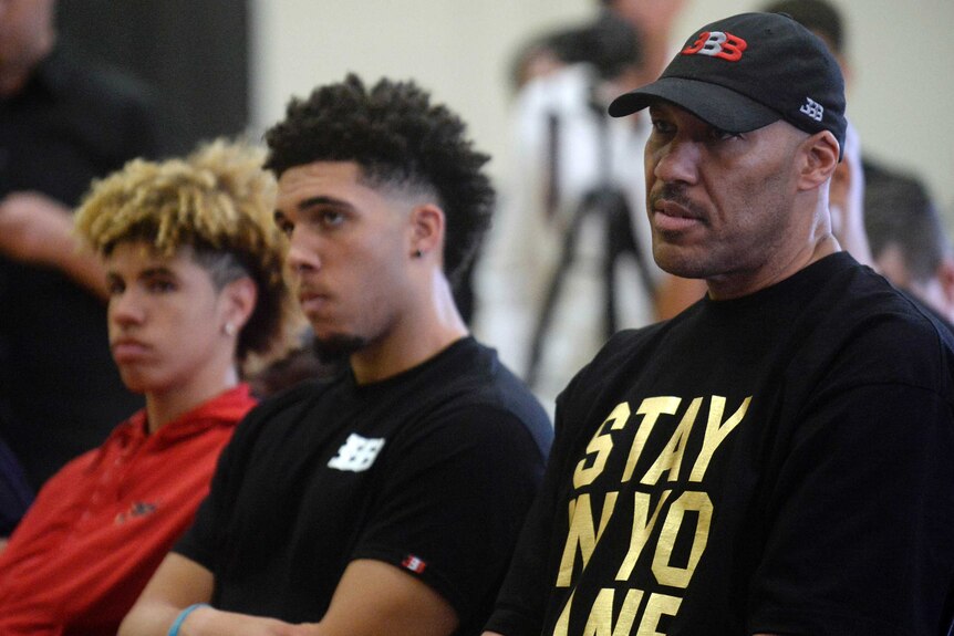 LaVar Ball (right) sits with sons LiAngelo (centre) and LaMelo (left).