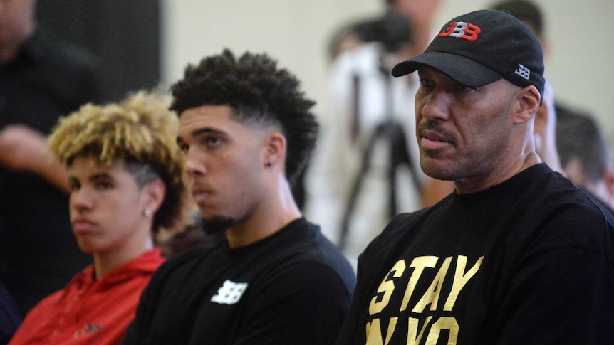 LaVar Ball (right) sits with sons LiAngelo (centre) and LaMelo (left).