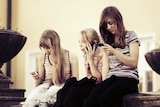 Young girls using mobile phones.