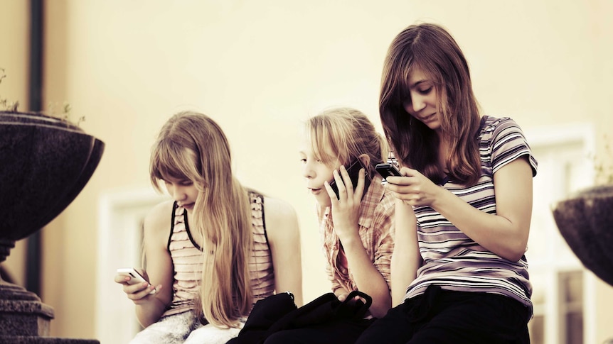 Young girls using mobile phones.