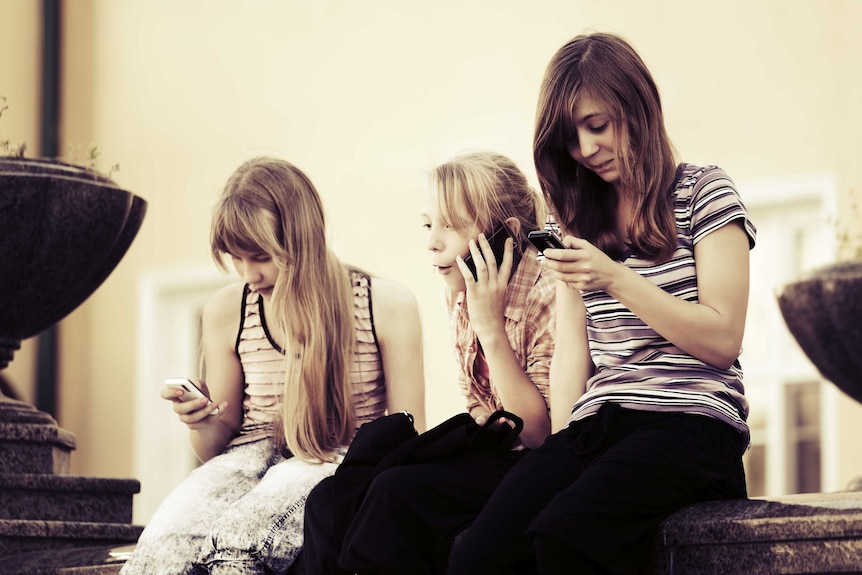 Young girls using mobile phones.