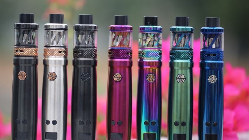 Picture of colourful vapes standing upright ranging from blue, purple to black
