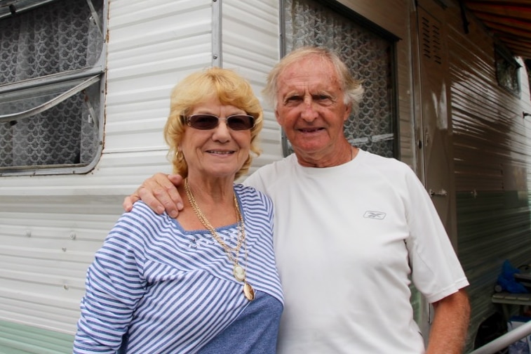 Older couple Ray and Annie Barrow standing in front of their retro caravan at Kiama caravan park