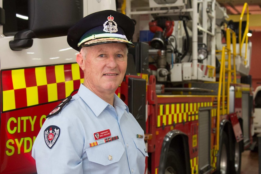 FRNSW Commissioner Greg Mullins stands in front of a fire truck