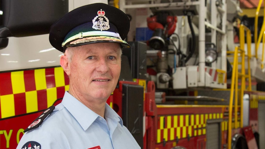 FRNSW Commissioner Greg Mullins stands in front of a fire truck