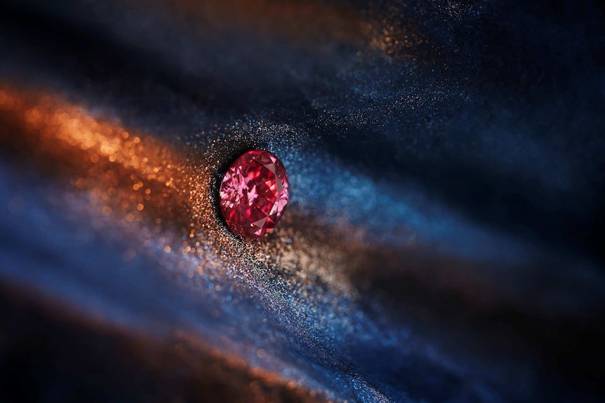 Red diamond closeup on colourful background