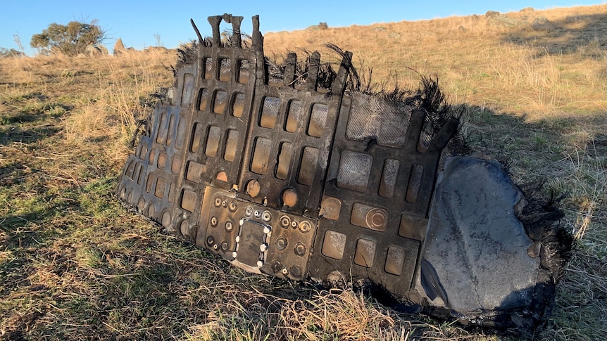 a piece of space junk sitting in a paddock