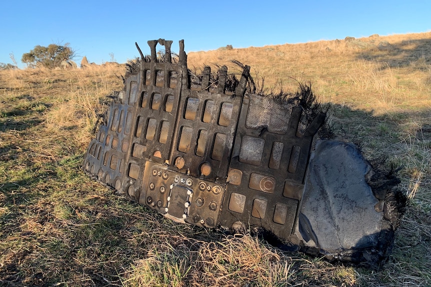 a piece of space junk sitting in a paddock