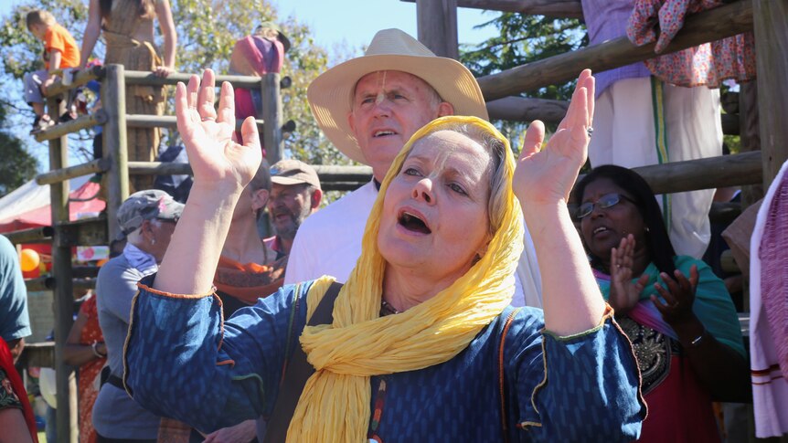 Hare Krishna woman with hands raised