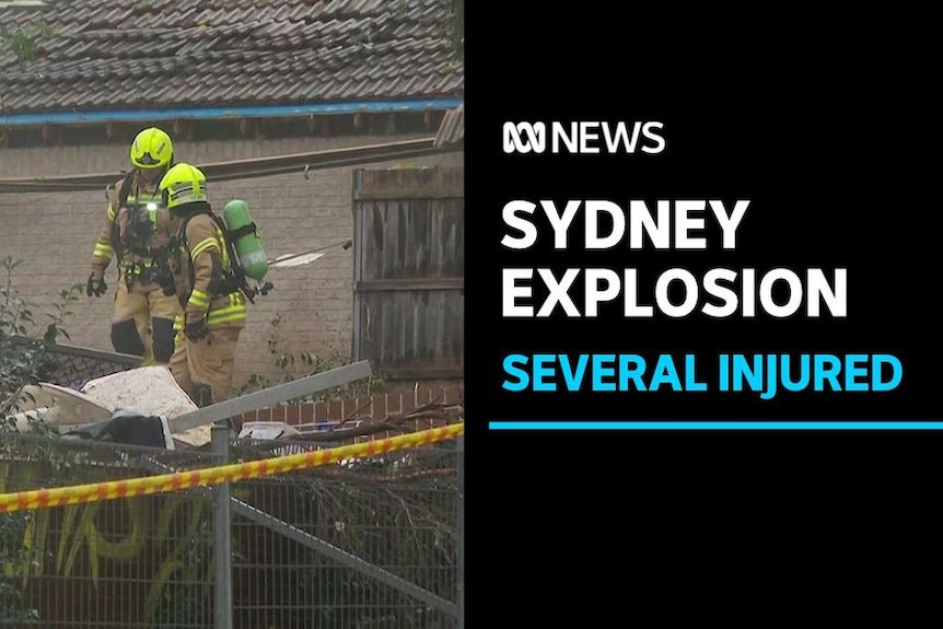 Sydney Explosion, Several Injured: Two fire and rescue crew members wear yellow uniform stand on house debris.