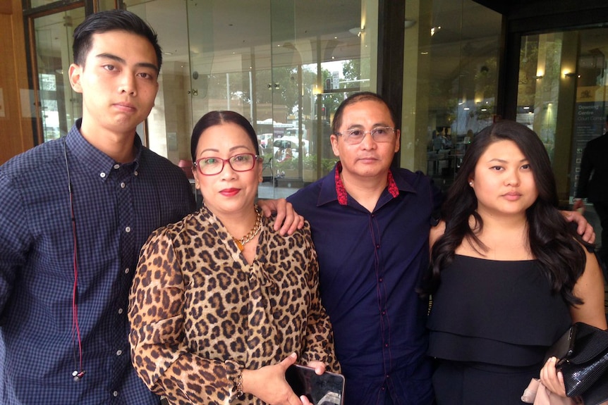Teresita and Roul Manalad with two of their son's friends, outside a Sydney court