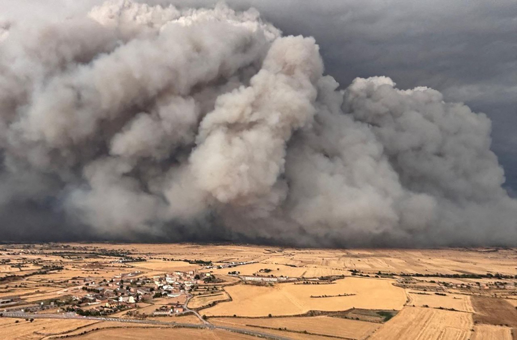 Smoke rises from a wildfire over the fields of Torrefeta i Florejacs vile, near Lleida, Spain July 1