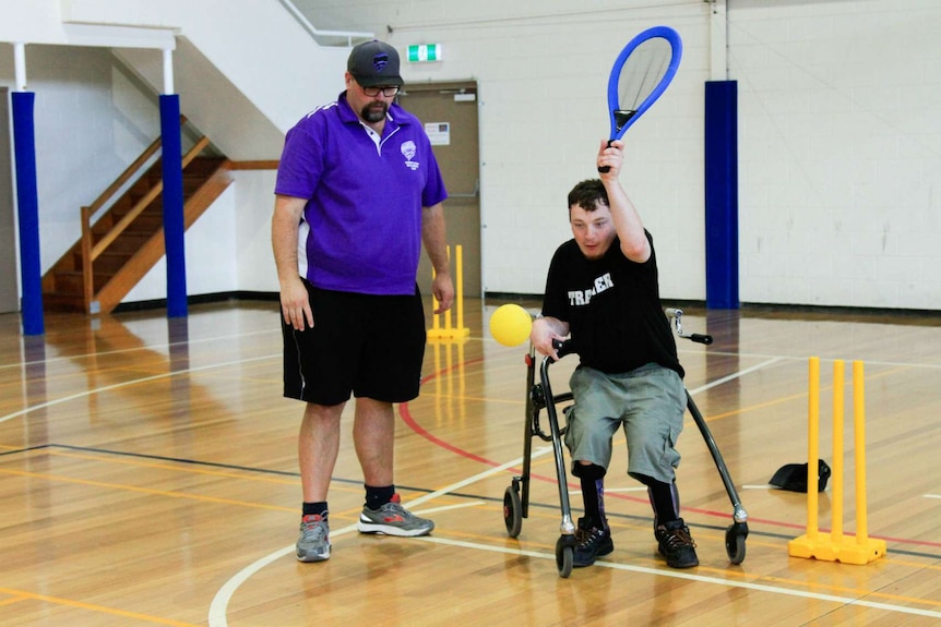 Jason Schmidt from Cricket Tasmania with a young player at the Inclusion Cup.