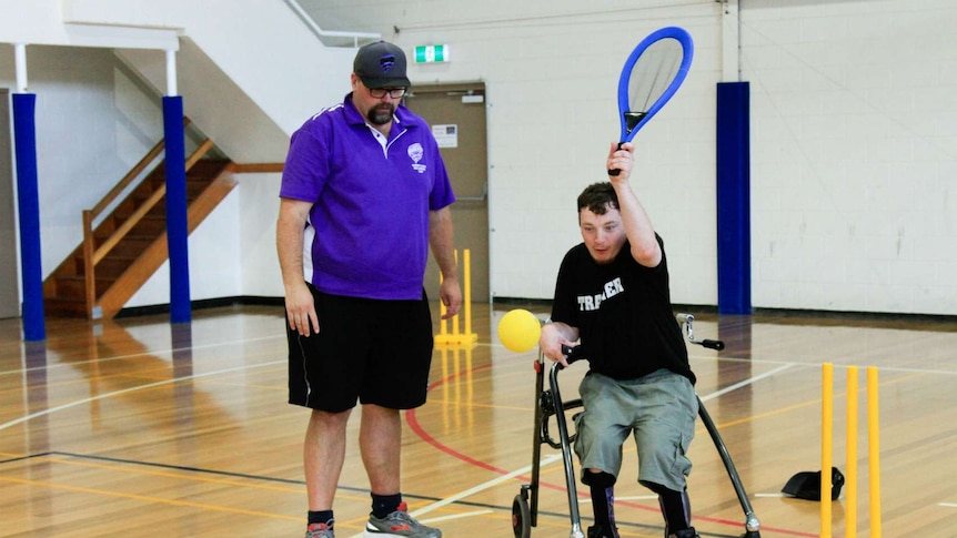 Jason Schmidt from Cricket Tasmania with a young player at the Inclusion Cup.