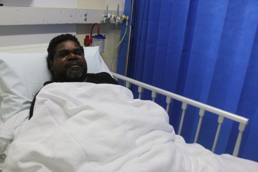 Elston Lami Lami, 42, recovering in his hospital bed at Royal Darwin Hospital after stepping on a crocodile at Minjilang.