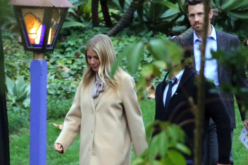 Gwyneth Paltrow walks down a driveway.