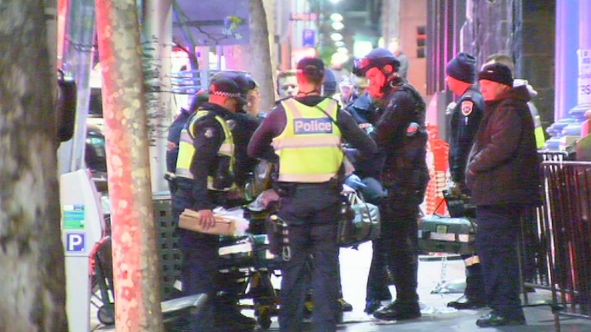 Police around an ambulance stretcher outside a nightclub in King Street in Melbourne's CBD after two people were shot.