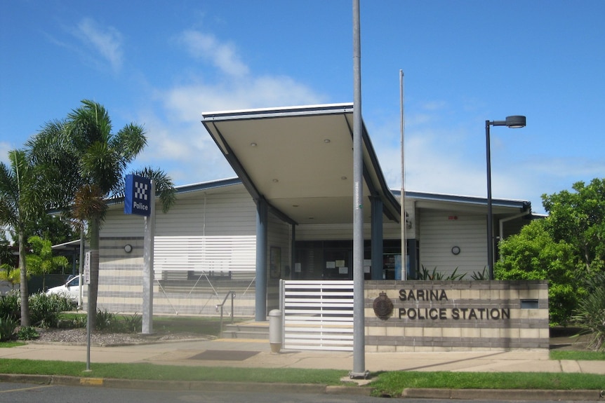 A country police station beneath a sunny sky.