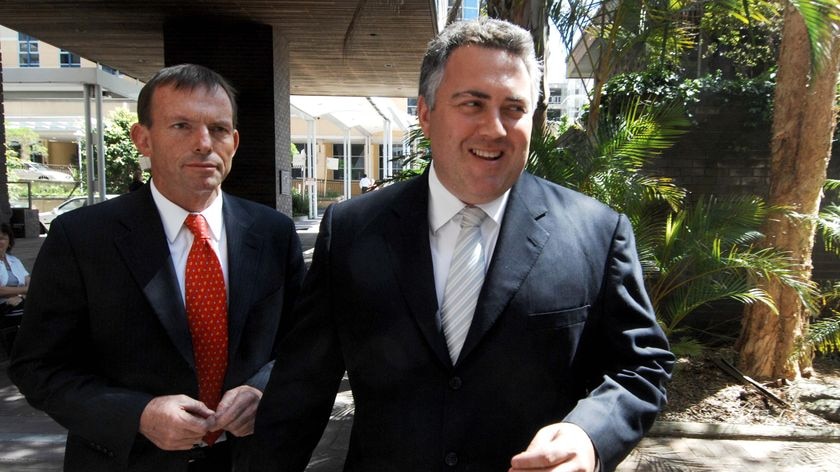 Wide photo of Tony Abbott (left) and Joe Hockey walking outside. Joe with big grin, Oct. 2, 2007,