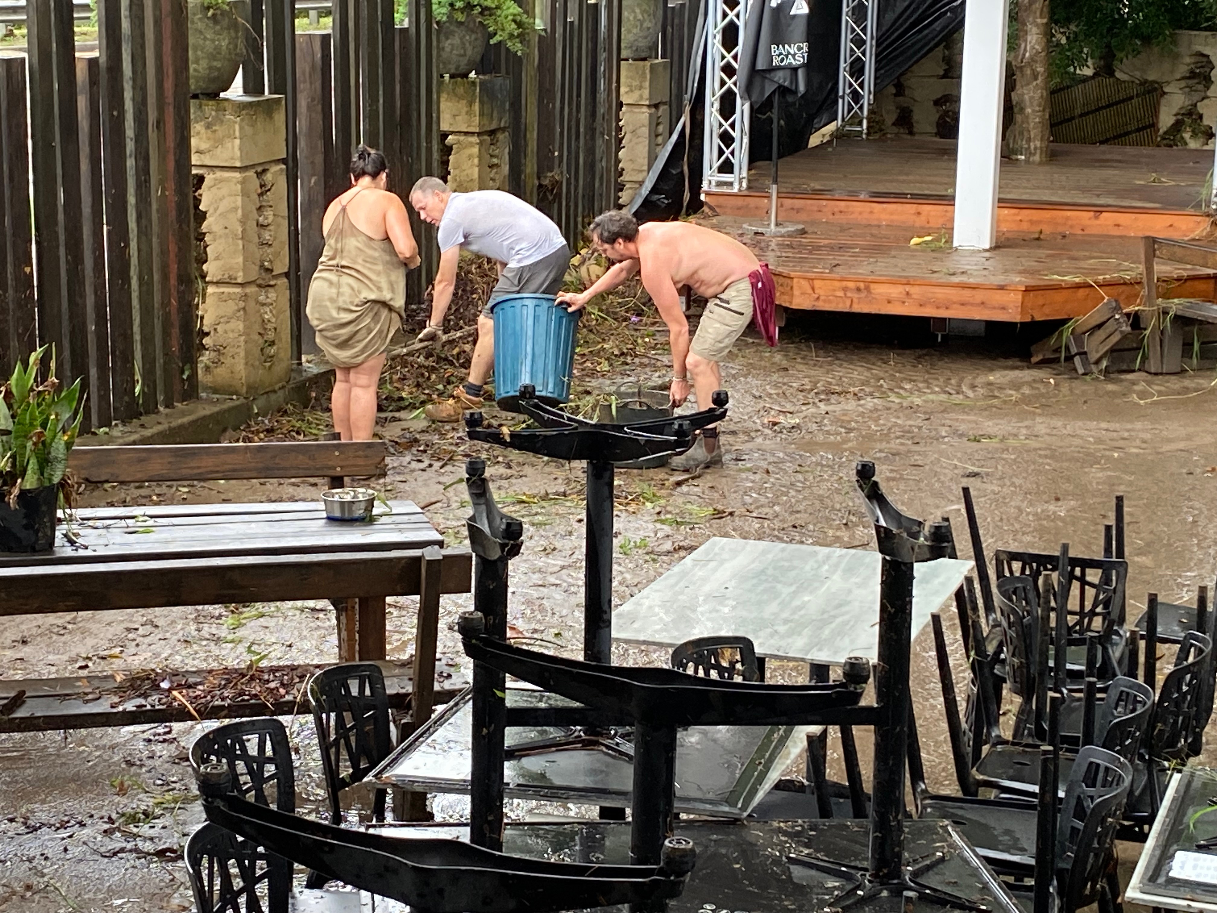 people cleaning up after their business was flooded in Samford