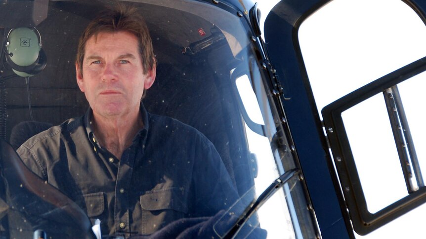 Paul Lockyer sits in the ABC helicopter at Lake Eyre