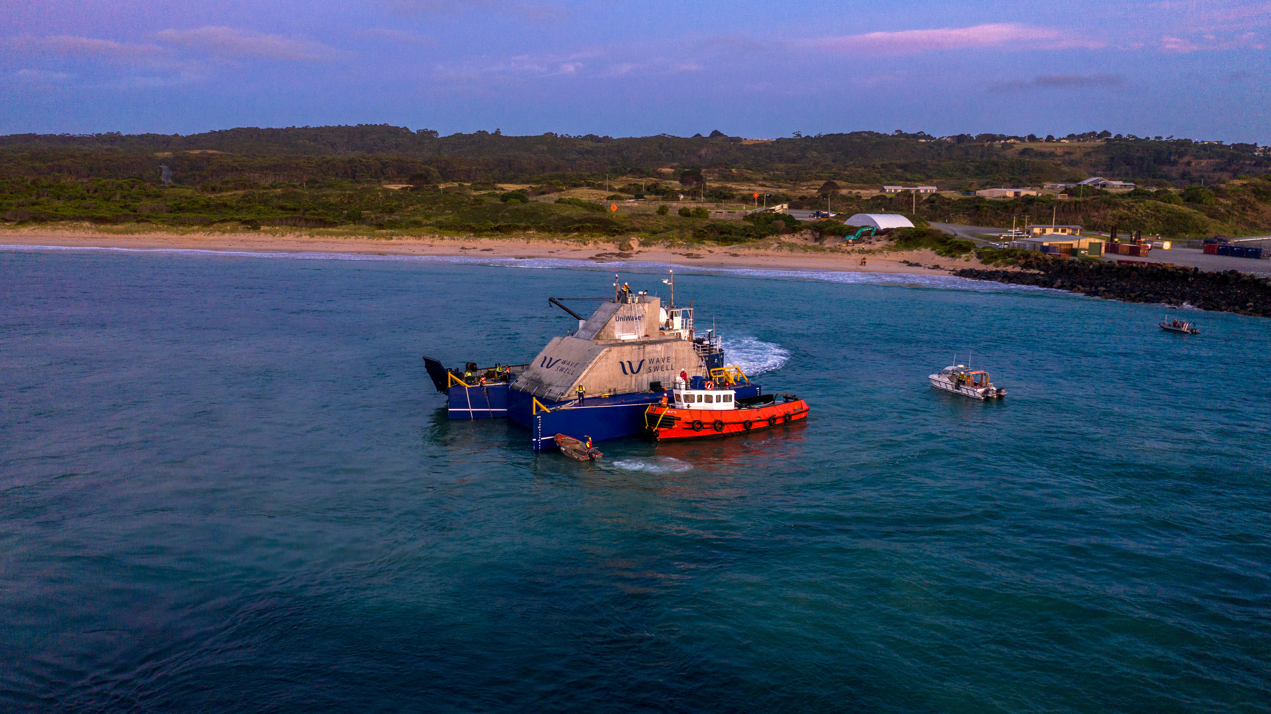A tug boat alongside the UniWave200 power generator.