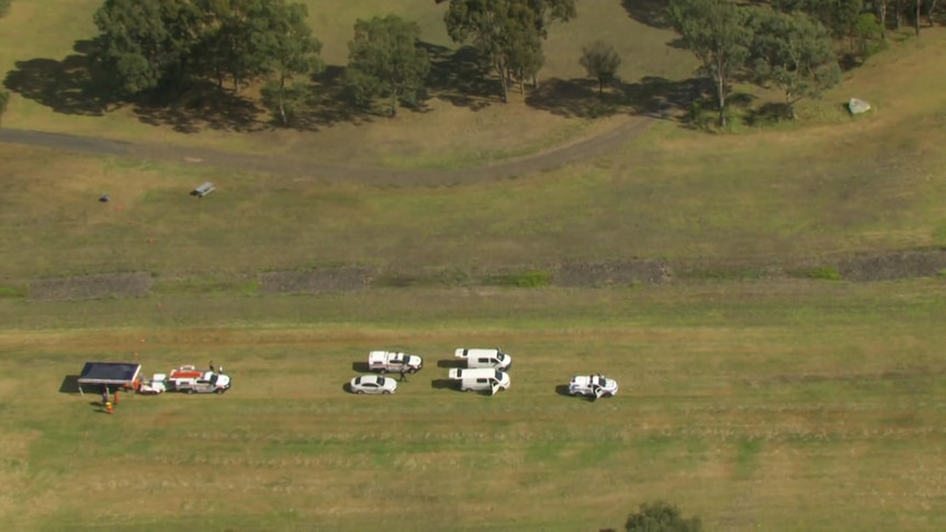 A bird's eye view of police vehicles in a park.