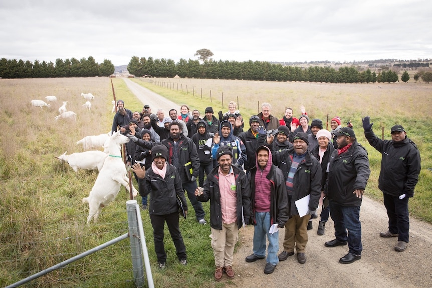 Papuan agriculturalists pose for group photo with goats