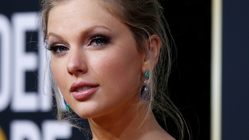 A headshot of Taylor Swift, hair pulled back, at the Golden Globes.