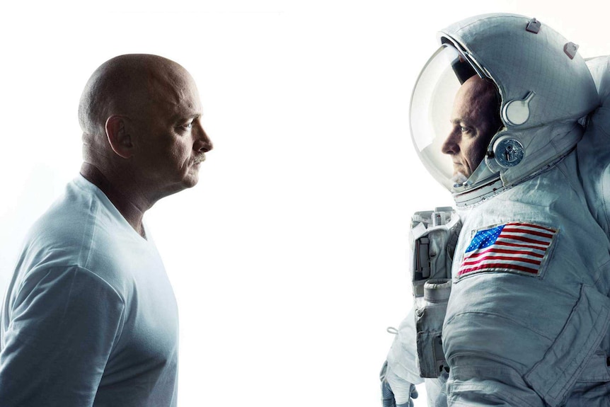 A man in a white shirt facing a man in an American space suit.