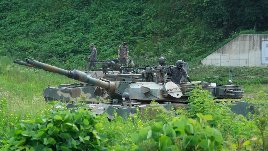 Soldiers drive a tank during South Korean military exercises.