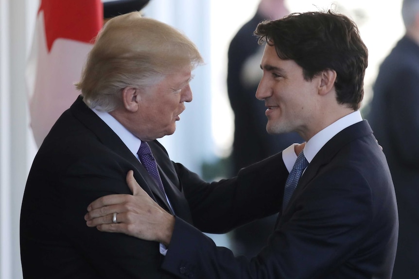 Canadian Prime Minister Justin Trudeau (R) is greeted by US President Donald Trump