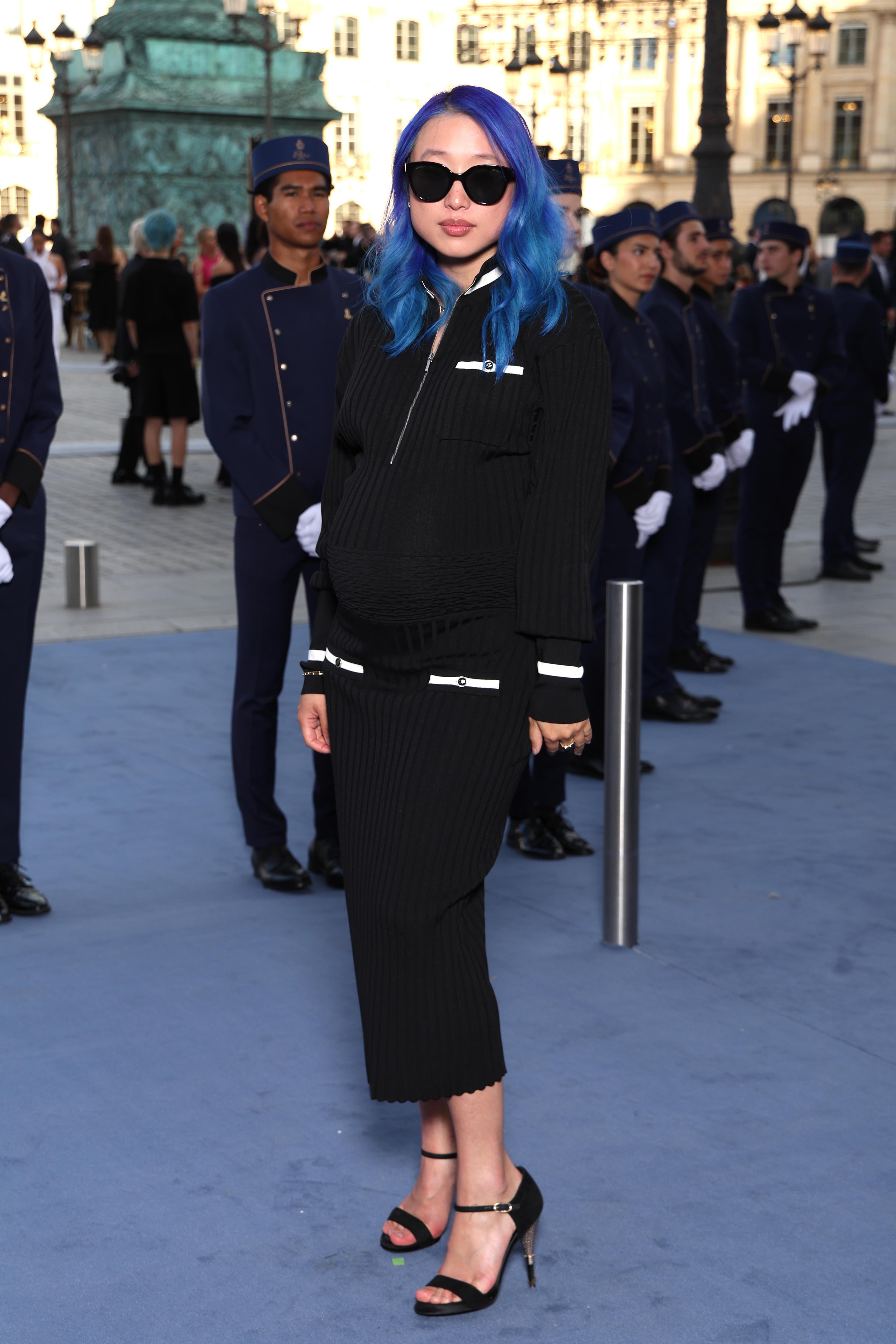 Margaret Zhang, who has blue hair, wears sunglasses and a black outfit