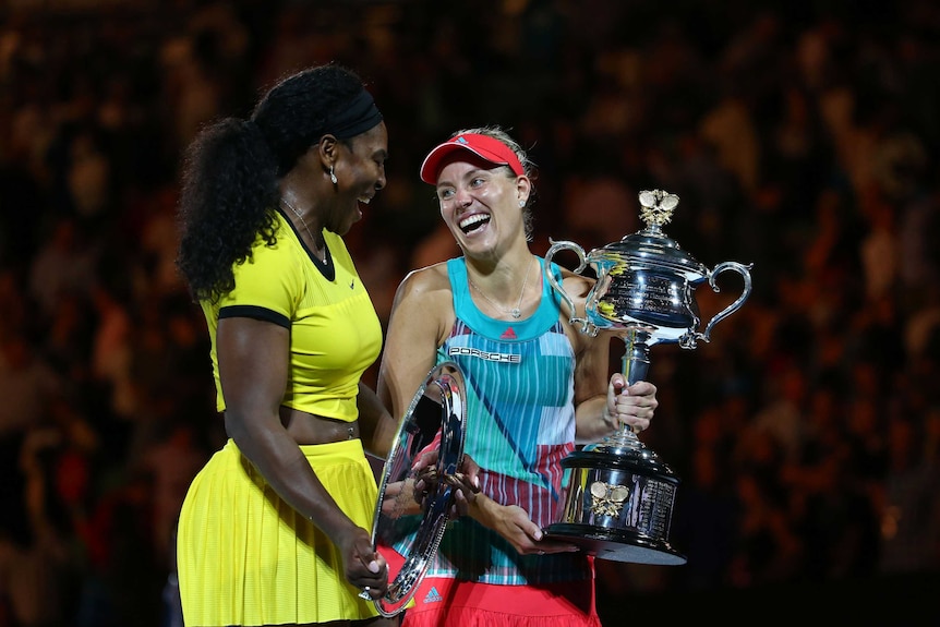 All smiles ... Angelique Kerber (R) poses with the Daphne Akhurst Memorial Cup alongside Serena Williams