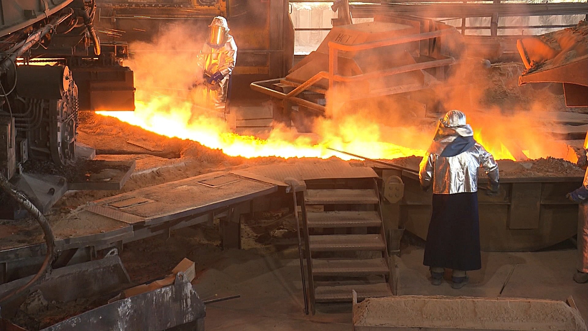 Workers inside a metallurgical plant.
