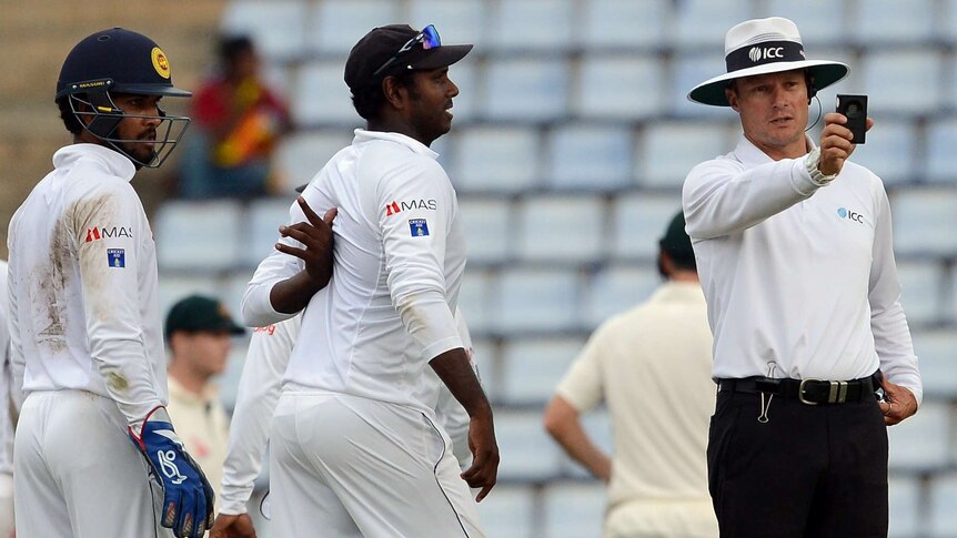 Umpire Richard Kettleborough checks light on day four of first Test between Australia and Sri Lanka.