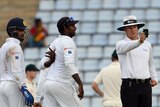 Umpire Richard Kettleborough checks light on day four of first Test between Australia and Sri Lanka.