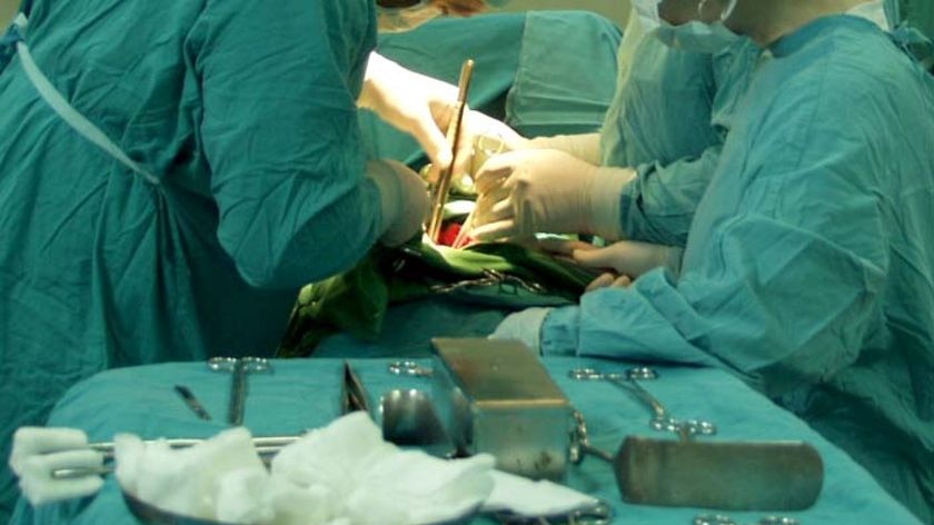 Two surgeons operate on a patient