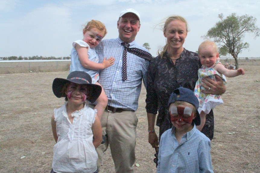 Ben and Lara Hawke pictured at the Come by Chance racecourse, with their four young children.