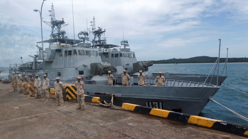 Sailors stand guard near petrol boats at the Cambodian Ream Naval Base.