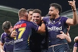 NRL players wearing purple converge and celebrate triumph after scoring