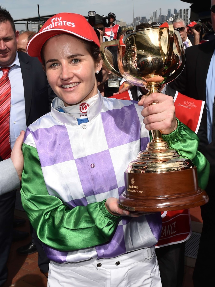 Michelle Payne holds the Melbourne Cup after winning on Prince of Penzance at Flemington in 2015.