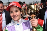 Michelle Payne holds the Melbourne Cup after winning on Prince of Penzance at Flemington in 2015.