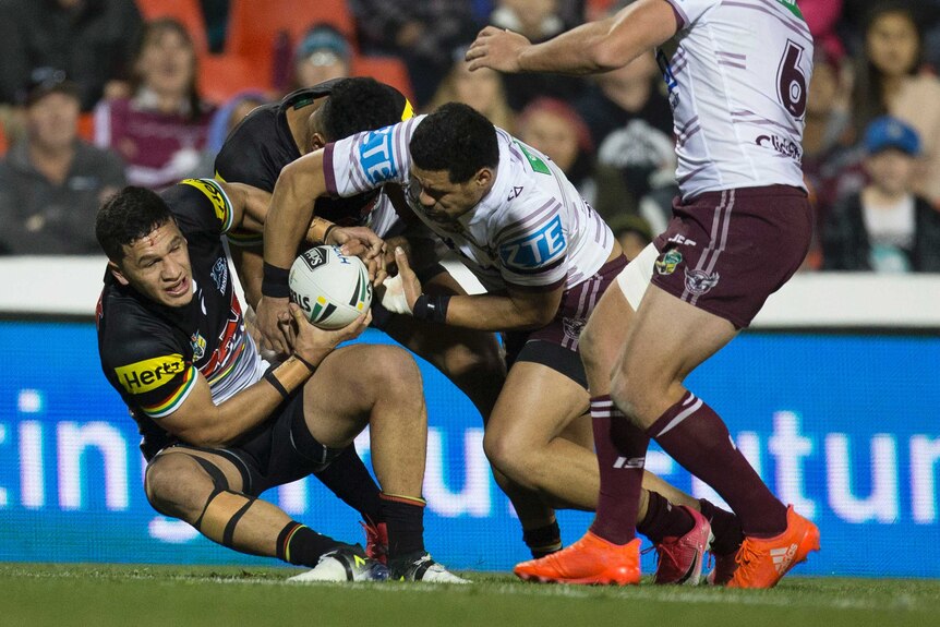 Dallin Watene Zelezniak of the Panthers (L) scores against Manly at Penrith Stadium.