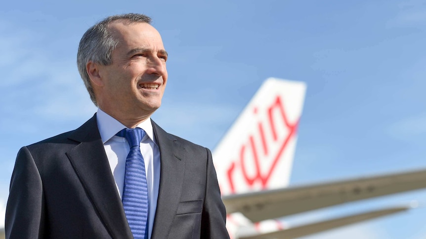 Virgin Australia CEO John Borghetti stands beside an Airbus A330 in Sydney.