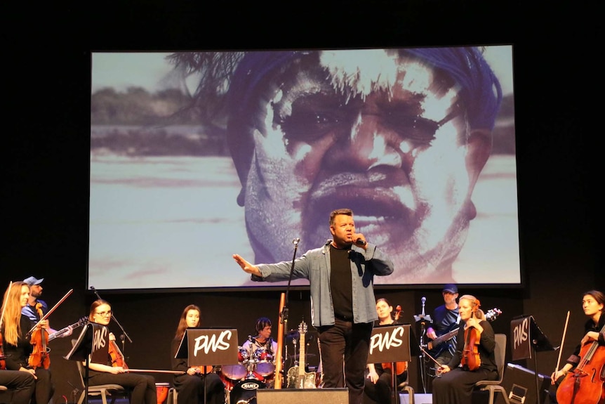 Phil Walleystack rehearses with the orchestra.