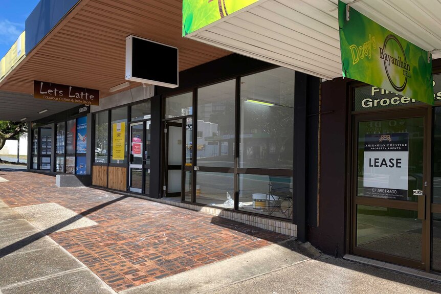 Row of empty shops in Nerang St Southport one with lease sign