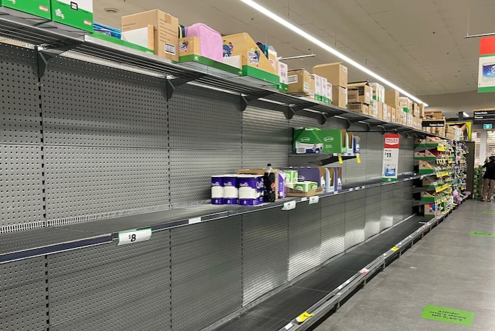 An almost empty shelf in a supermarket.