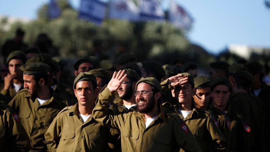 Soldiers of the Netzah Yehuda Haredi infantry battalion in green ourits during swearing in